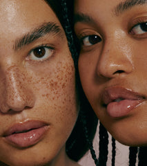a pair of models with glossy lips