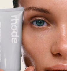 model holding a brc next to her face