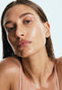hailey bieber with glazed skin, wearing peptide lip treatment