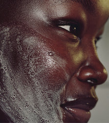 close up of model's face, lathered with pineapple refresh cleanser