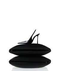 black high heels on two oversized bags