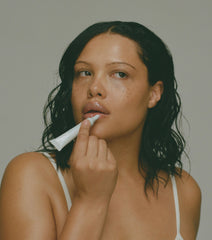 Model applying peptide lip treatment - unscented
