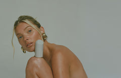 Model balancing glaze on leg, glowing skin