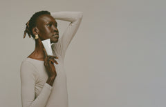 Model holding BRC, looking away with glowing skin