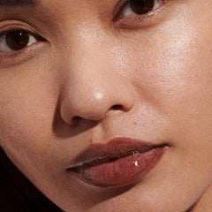 Model wears Peptide Lip Tint in shade Espresso