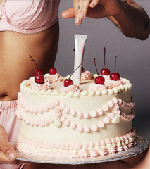 peptide lip treatment stuck on top of a vanilla cake