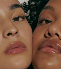 close up of two models with glossy lips