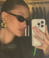 Hailey Bieber holding lip case with toast lip tint