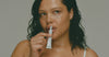 Model applying peptide lip treatment - cropped