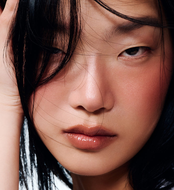 model wearing peptide lip shape in bend