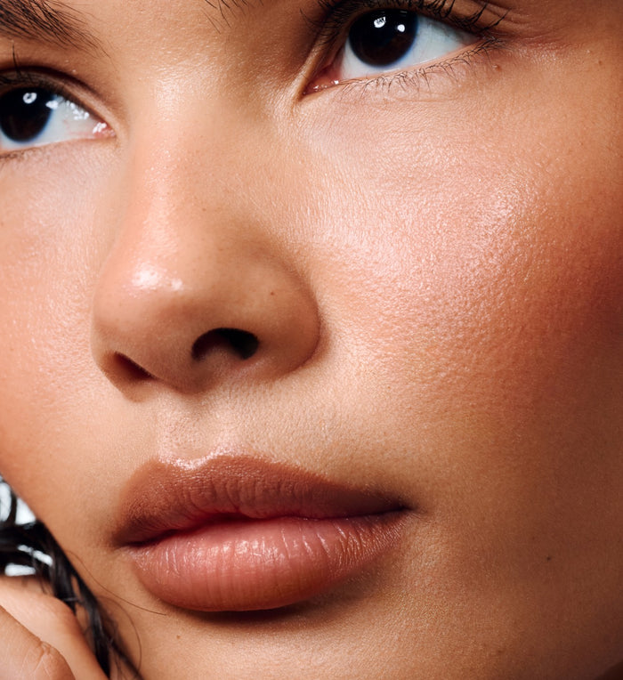 model wearing peptide lip shape in bend