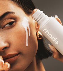 Hailey Bieber pouring Glazing Milk on face