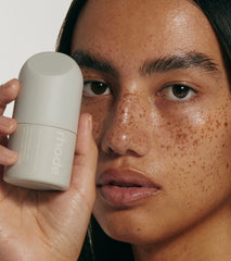 model holding peptide glazing fluid with glazed skin
