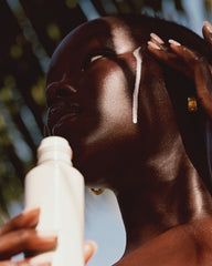 model applying glazing milk on skin