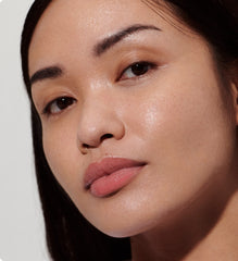 Model wears Peptide Lip Tint in shade Ribbon