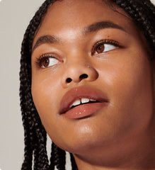 model wears peptide lip tint in shade toast