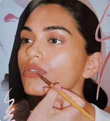 model with glossy lips, wearing toast lip tint