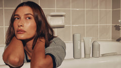 Hailey Bieber with glazed, hydrated skin next to the rhode skin collection