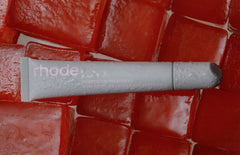 rhode lip treatment in watermelon flavor on top of red ice cubes