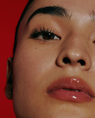 model wearing peptide lip treatment (watermelon slice)