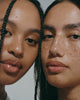 two models with dewy skin wearing peptide glazing fluid